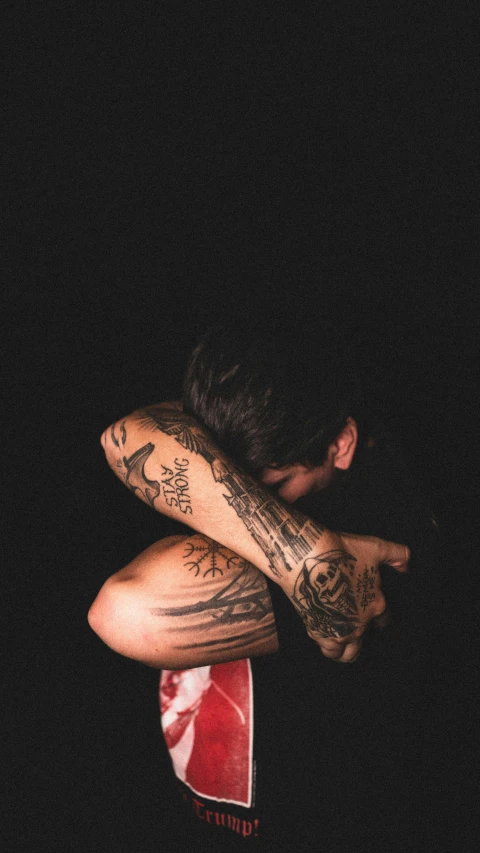 tattooed woman looking down on a red frisbee