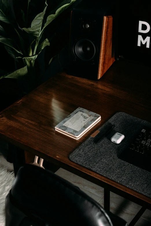 a coffee table with a phone, a keyboard and speakers