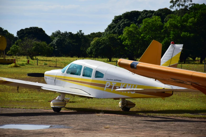 a small plane sitting on top of a grass field