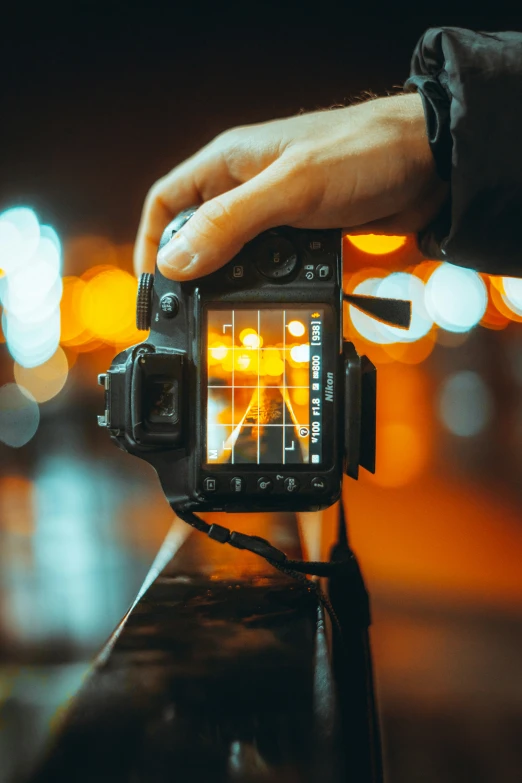 a man is holding his camera for the camera