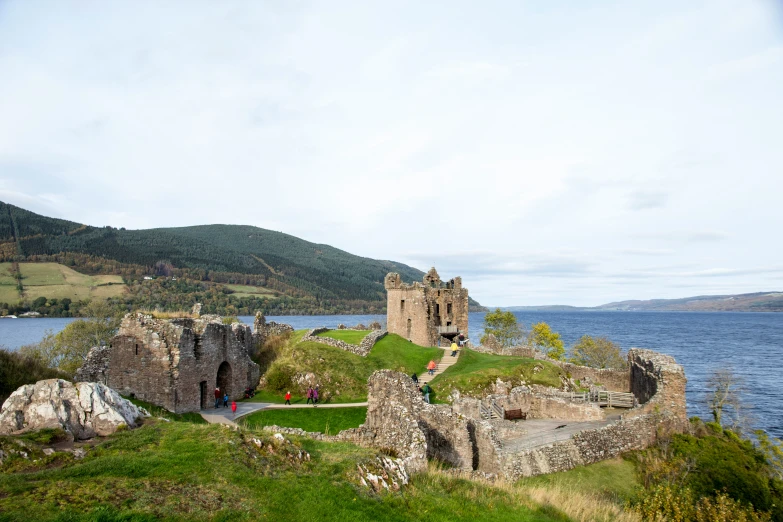 the castle overlooks an expansive lake and mountains