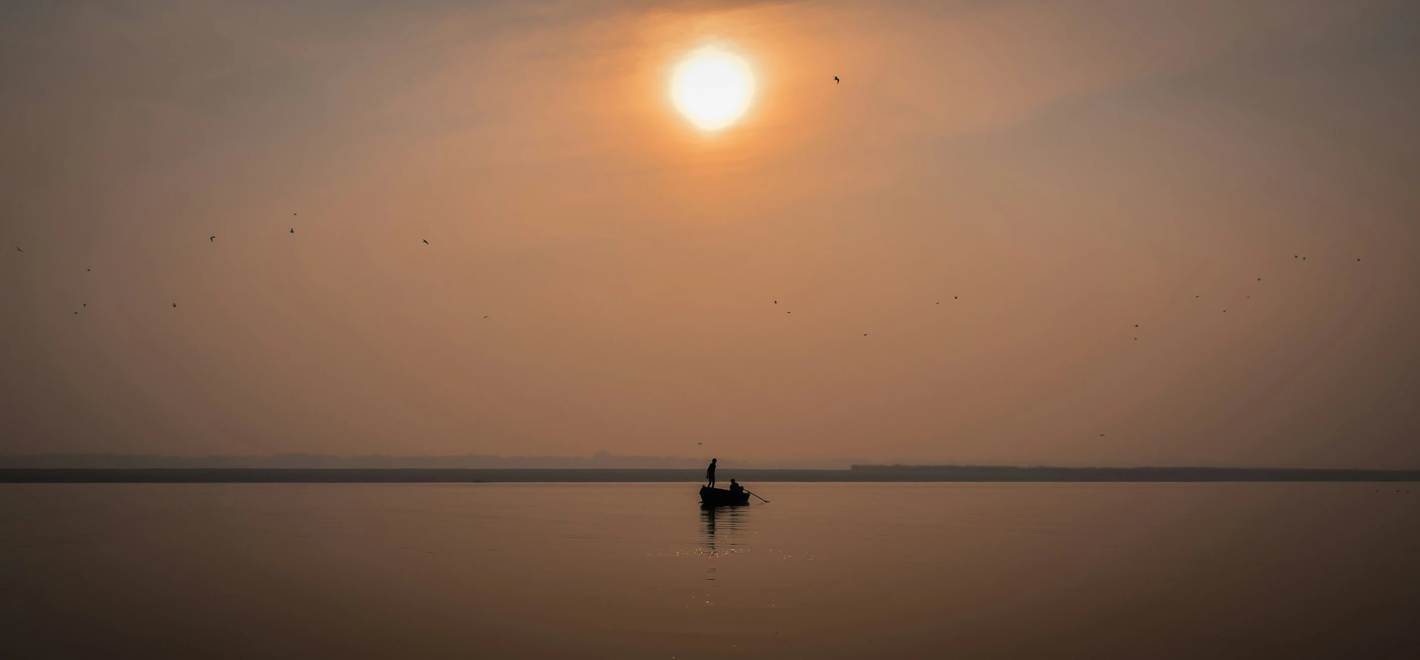 a person on a small boat on a calm river