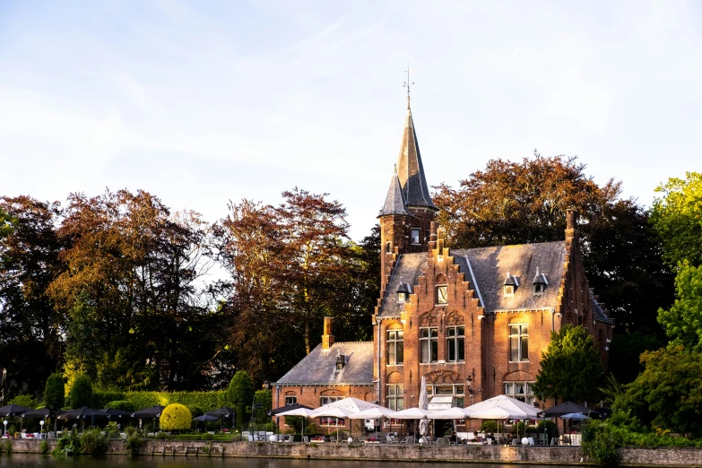 an old church with an out door restaurant and surrounding gardens