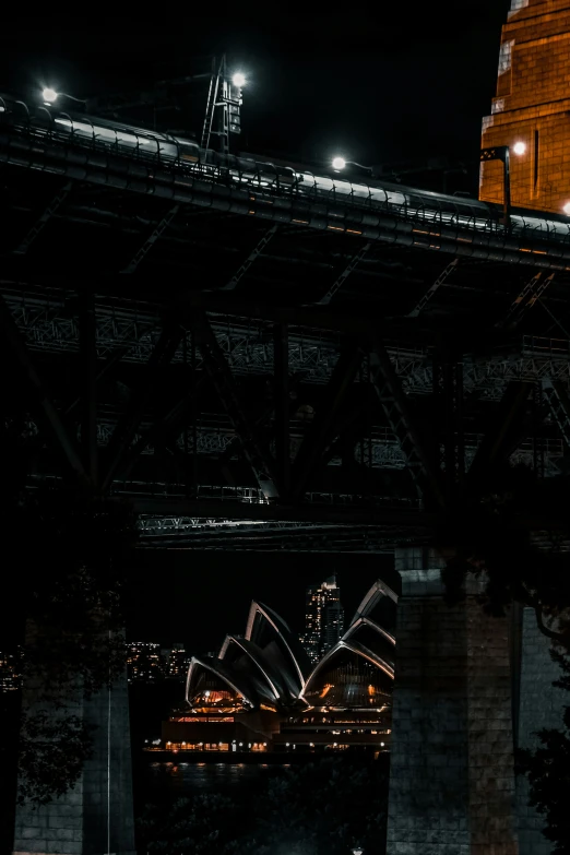 a train traveling over a bridge at night