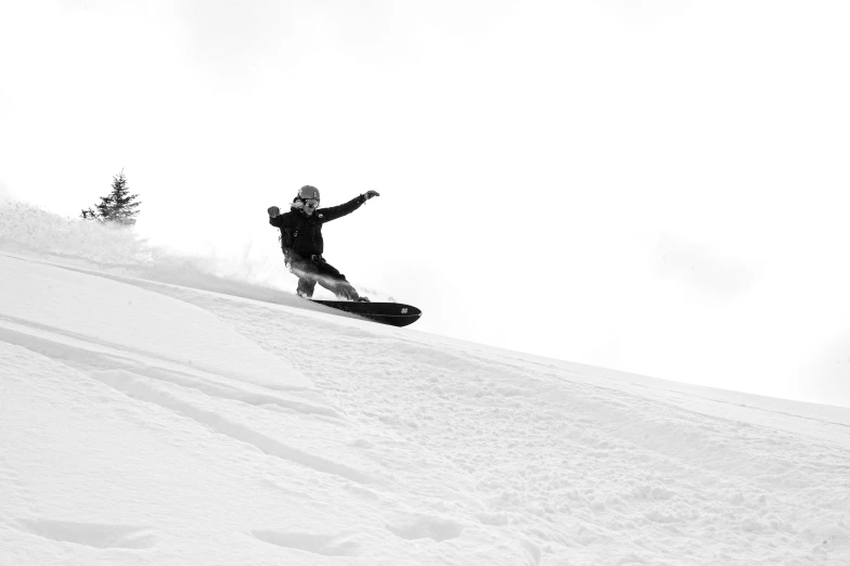 person snowboarding down the hill while one of them has their arms out