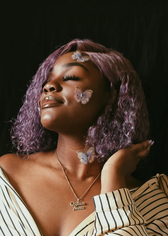 a black woman wearing purple hair wearing a necklace