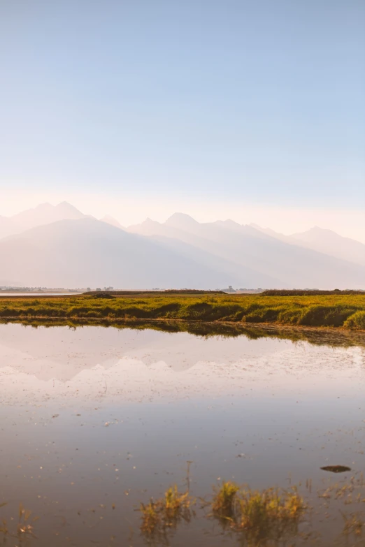 a body of water sitting below a mountain range