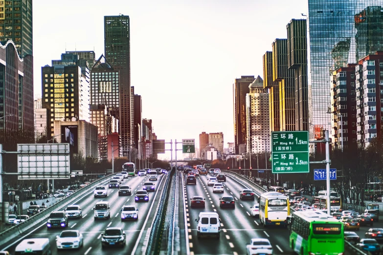 a city street filled with traffic and tall buildings