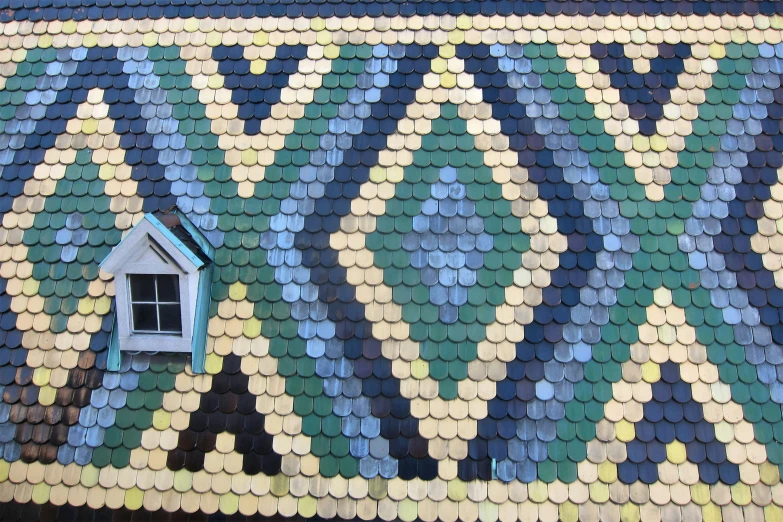 a bird house on the side of a roof made of tiles