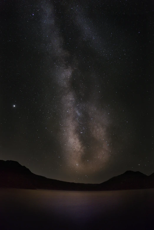 some stars in the night sky and some mountains