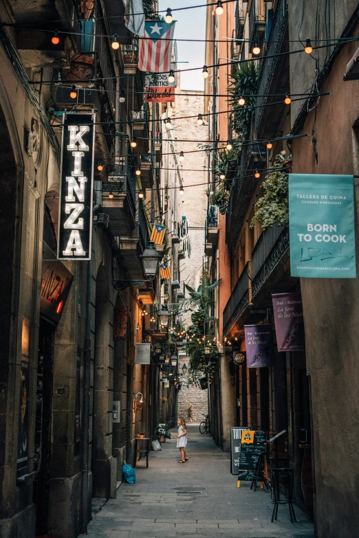 a narrow street is surrounded by tall buildings