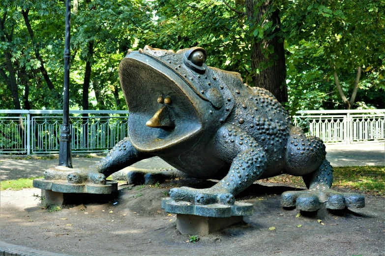 the statue of a frog is made of concrete