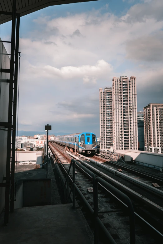 an elevated rail road track leads to a train station