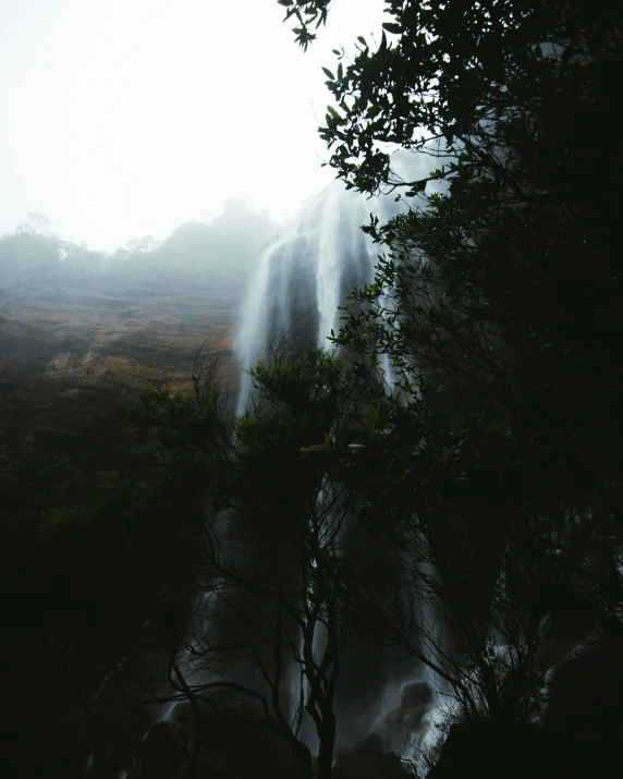 an umbrella sticking out of a waterfall in the distance