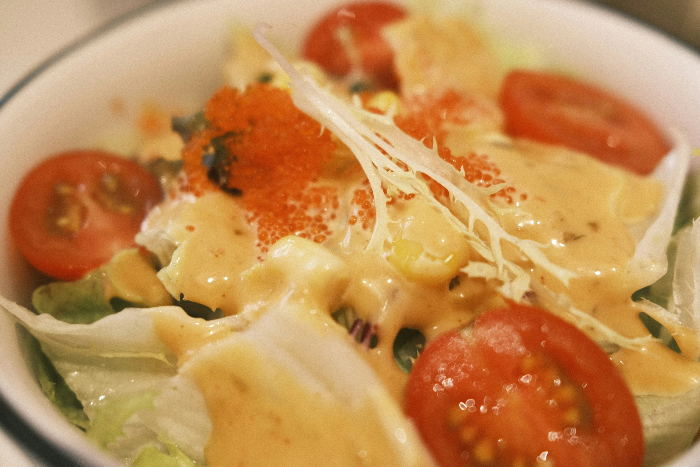 a bowl full of fresh food including tomatoes, cheese and noodles