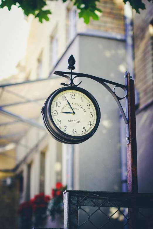 a small clock that is on the side of the building