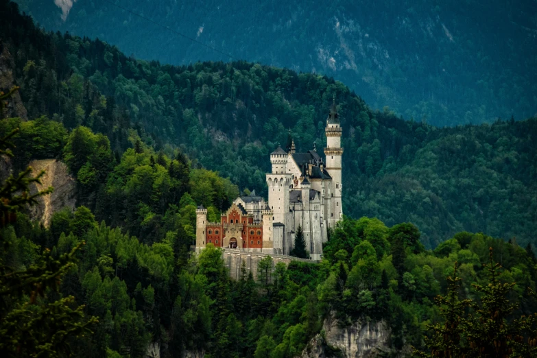 an old castle sits on a hill with trees in front of it