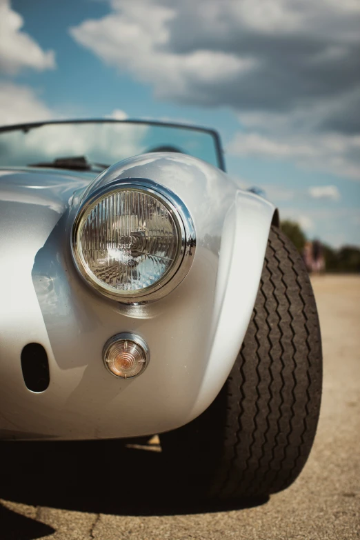 the front end of a white classic car