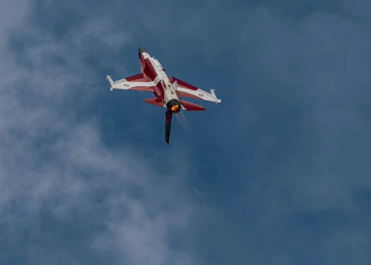 a fighter jet flies in an air filled with clouds