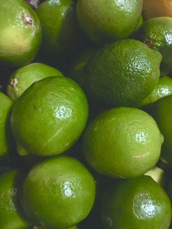 a large pile of limes in bright green color