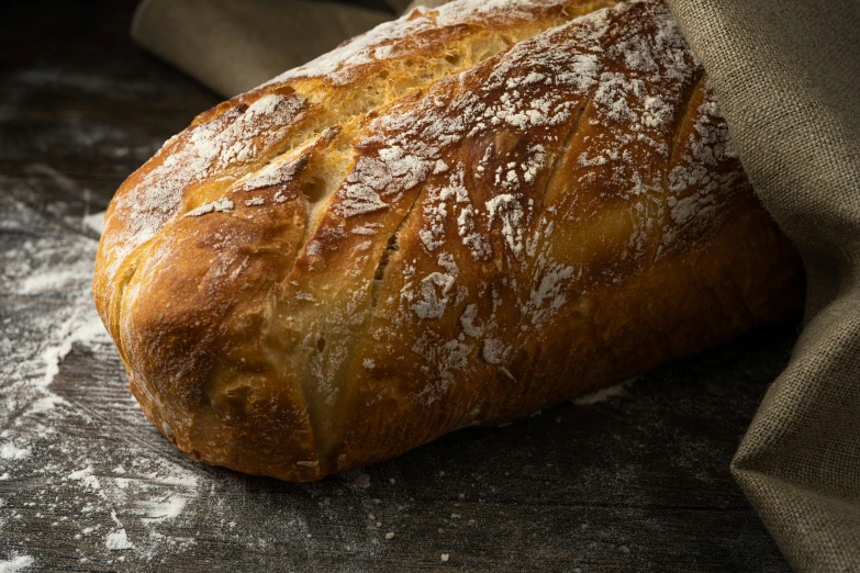 bread wrapped in some cloth on top of a table