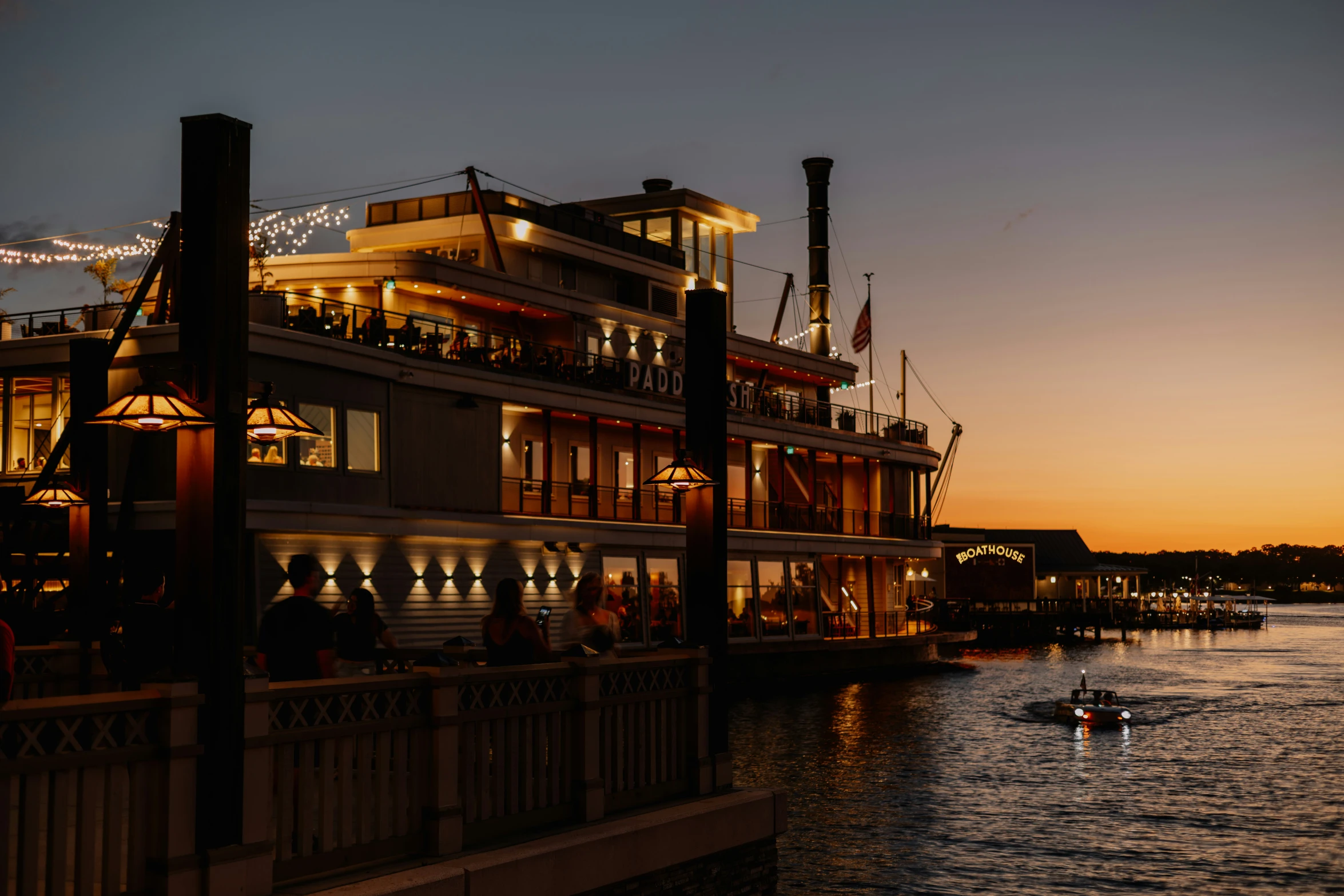 a boat is sailing in the water during the night