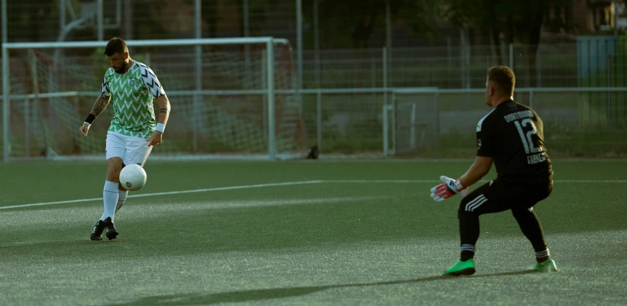 two men in black uniforms are on the soccer field