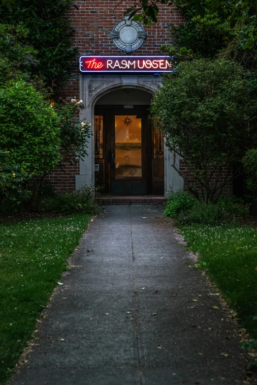 an entrance with a lighted sign that says the ramsay el