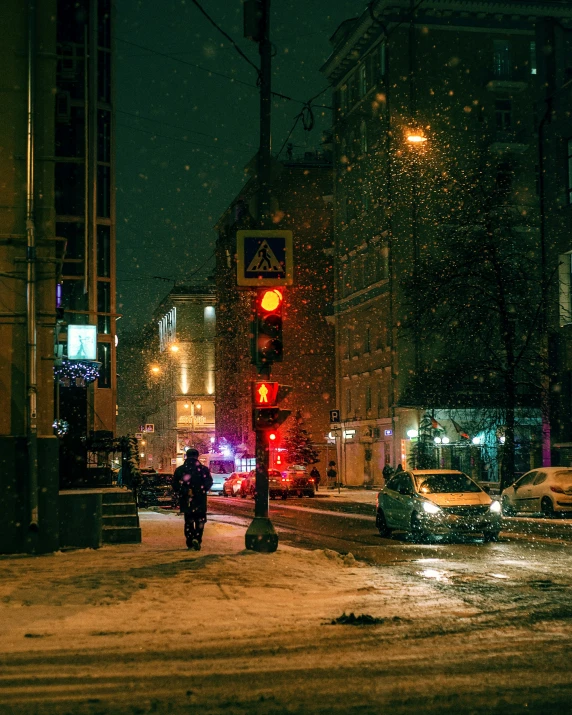 a person walking in the snow through an intersection