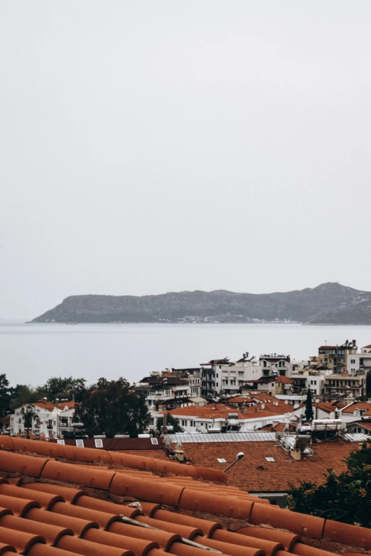 view of an ocean from a city next to a hillside