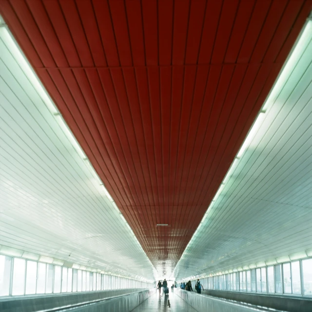 an underground walkway with lots of bright red lines