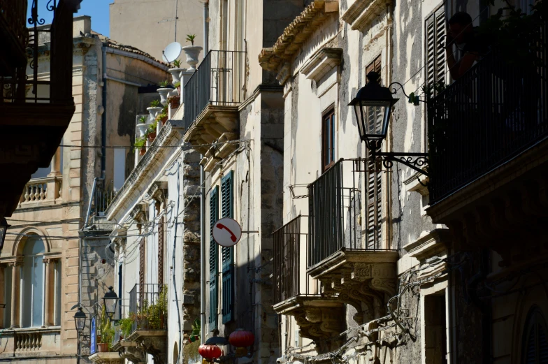 a street corner with several balconies on the buildings