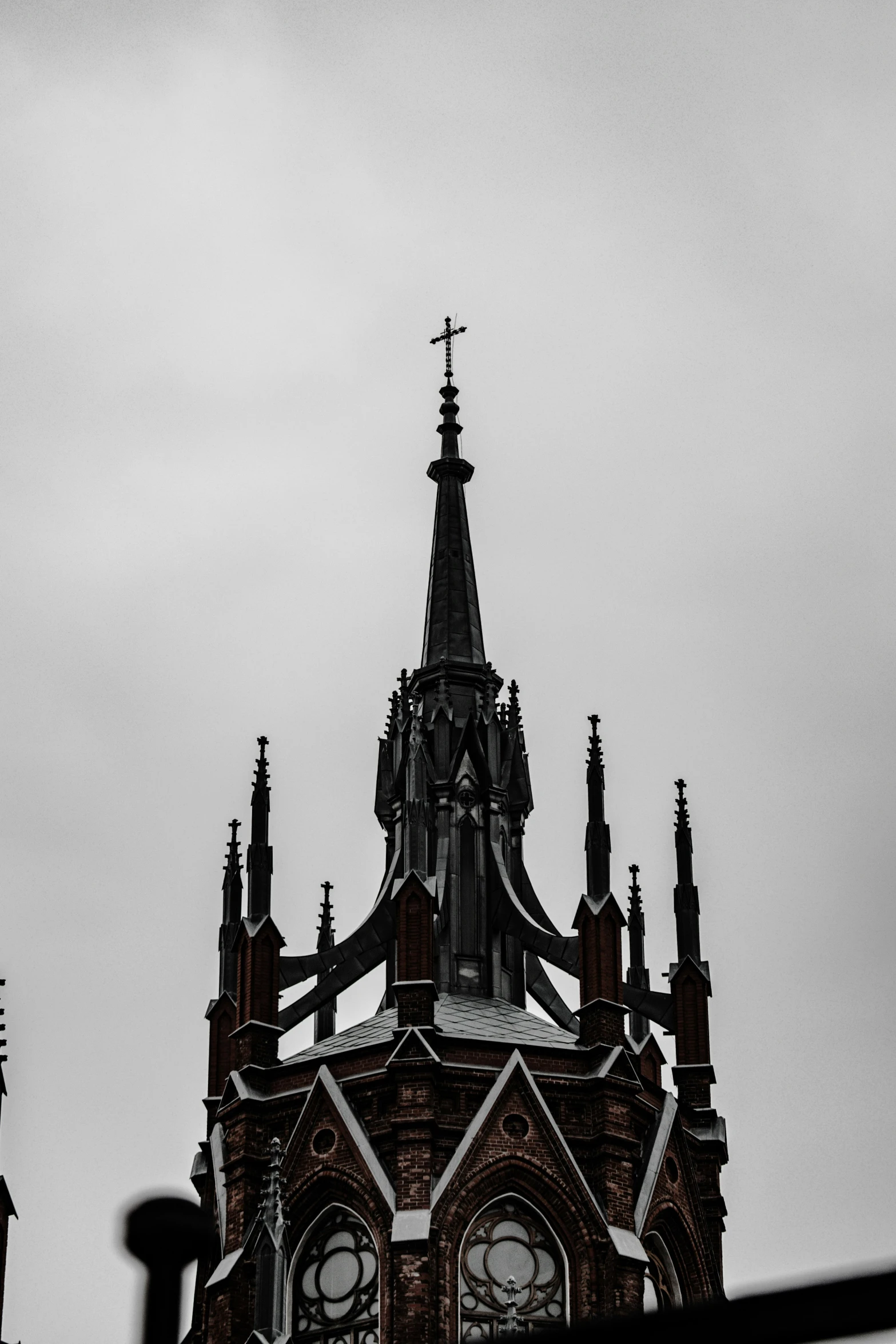 a church clock tower with steeple and cross at top