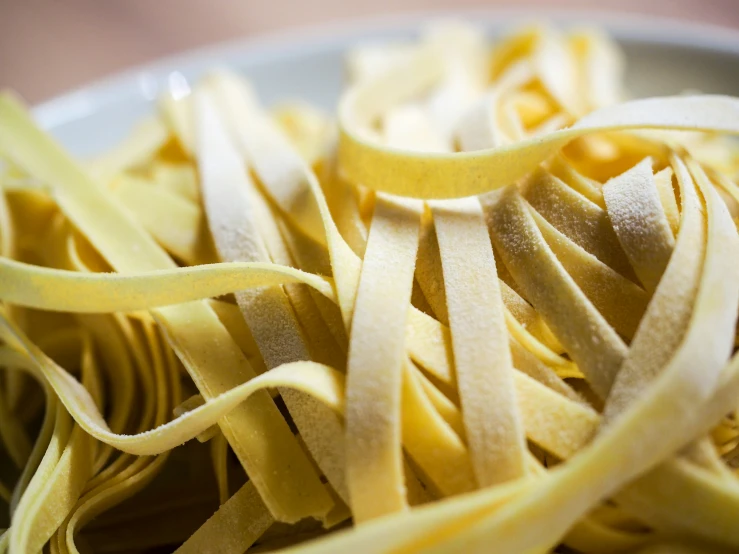 a bowl with several thin pasta pieces on it