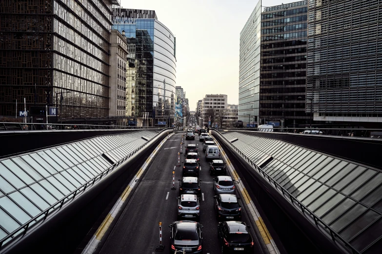 a wide highway between tall buildings in the city