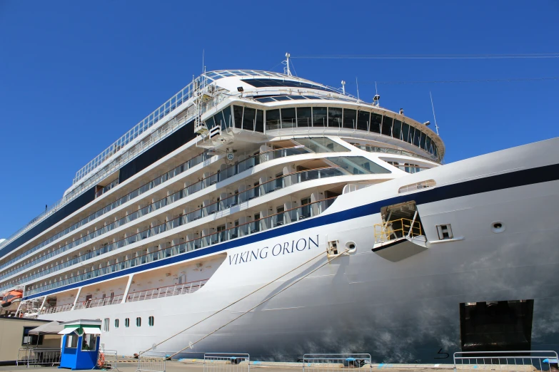 large white and blue cruise ship docked at a port