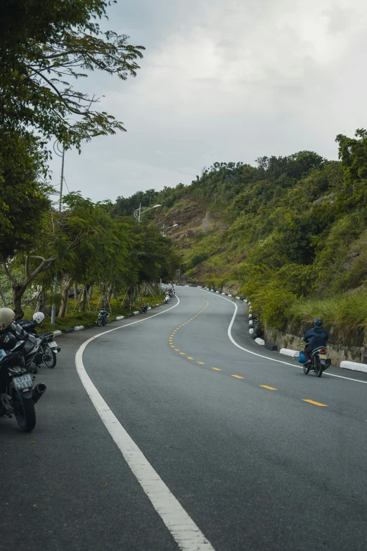 two motorcycles are driving down a curvy road