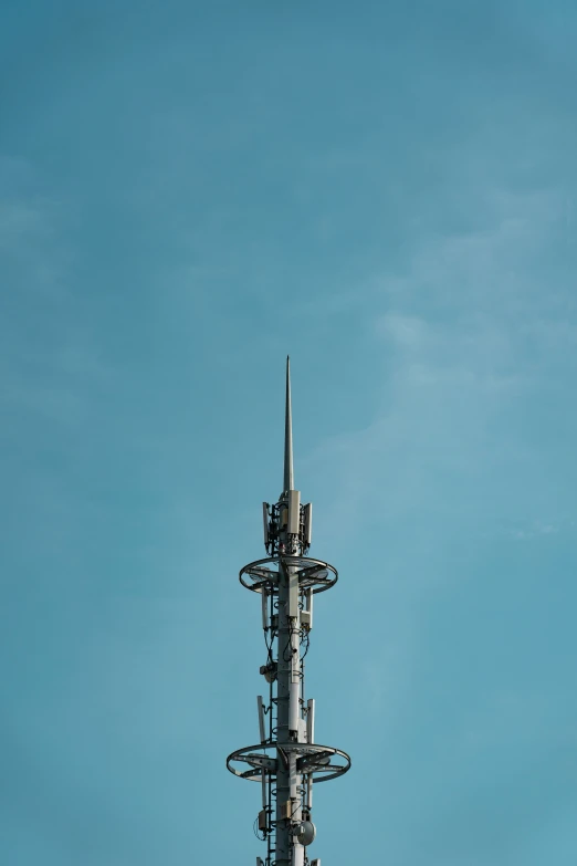 a tall tower with multiple antennas on top