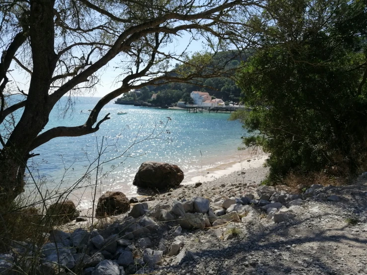 the water in a body of water surrounded by trees and rocks