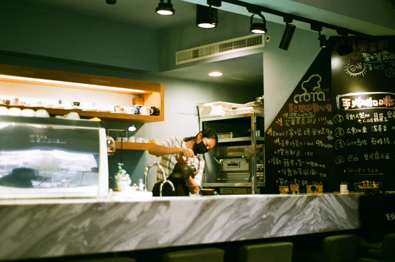 this is a person behind a counter in a restaurant