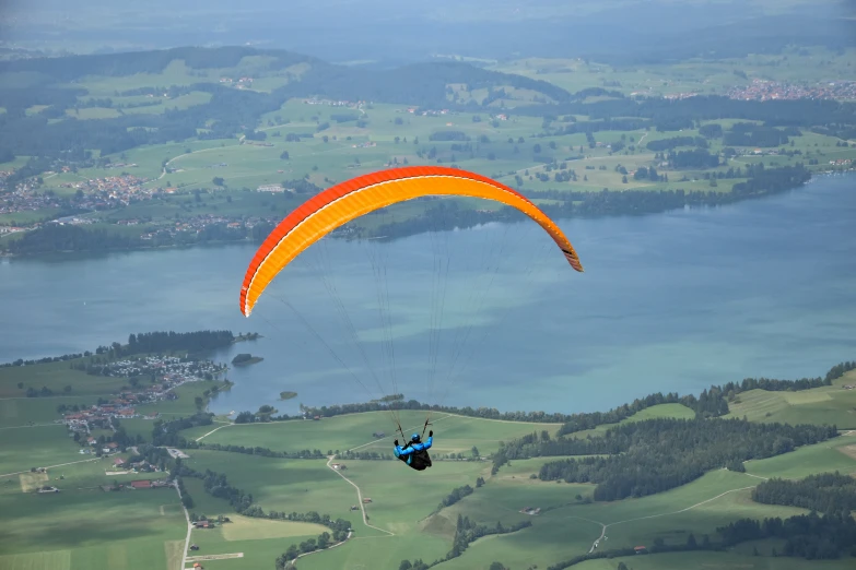 a paraglider is flying over an alpine landscape