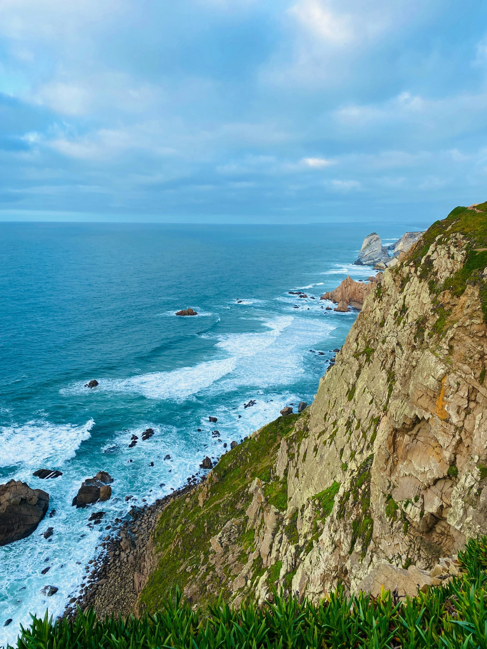 a view looking down on the beach and ocean