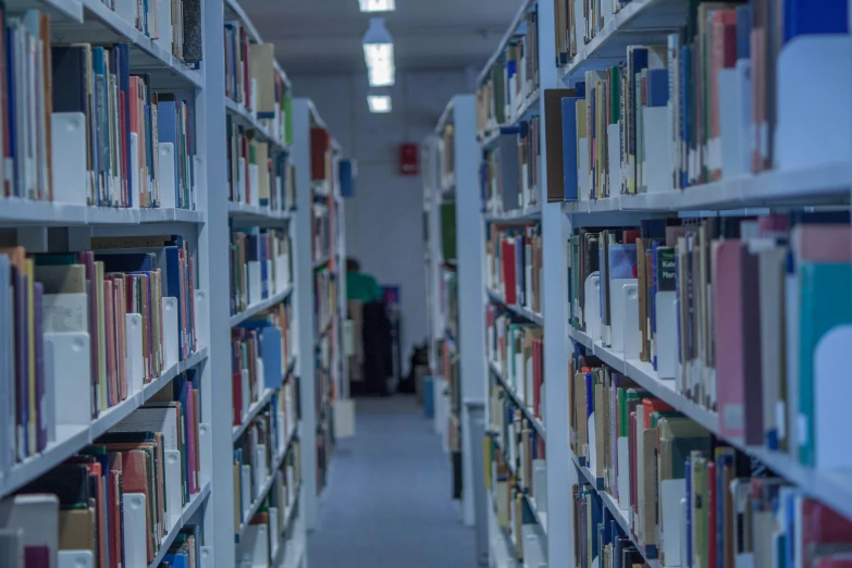 a long aisle between rows of book cases