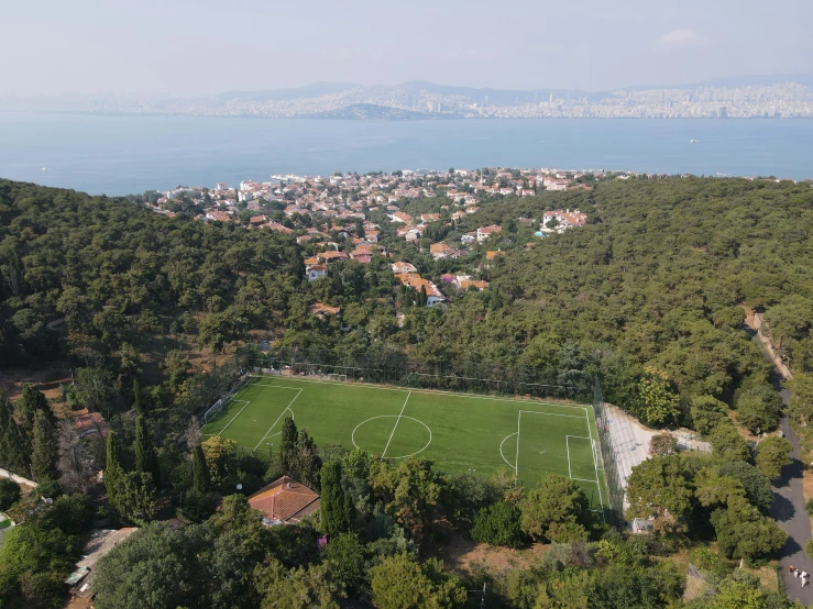 an aerial view of a city and a soccer field