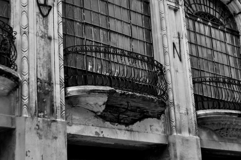 an old building with an iron balcony and window