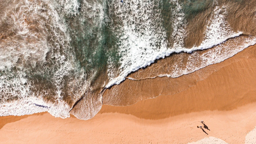 the top view of a beach next to the ocean