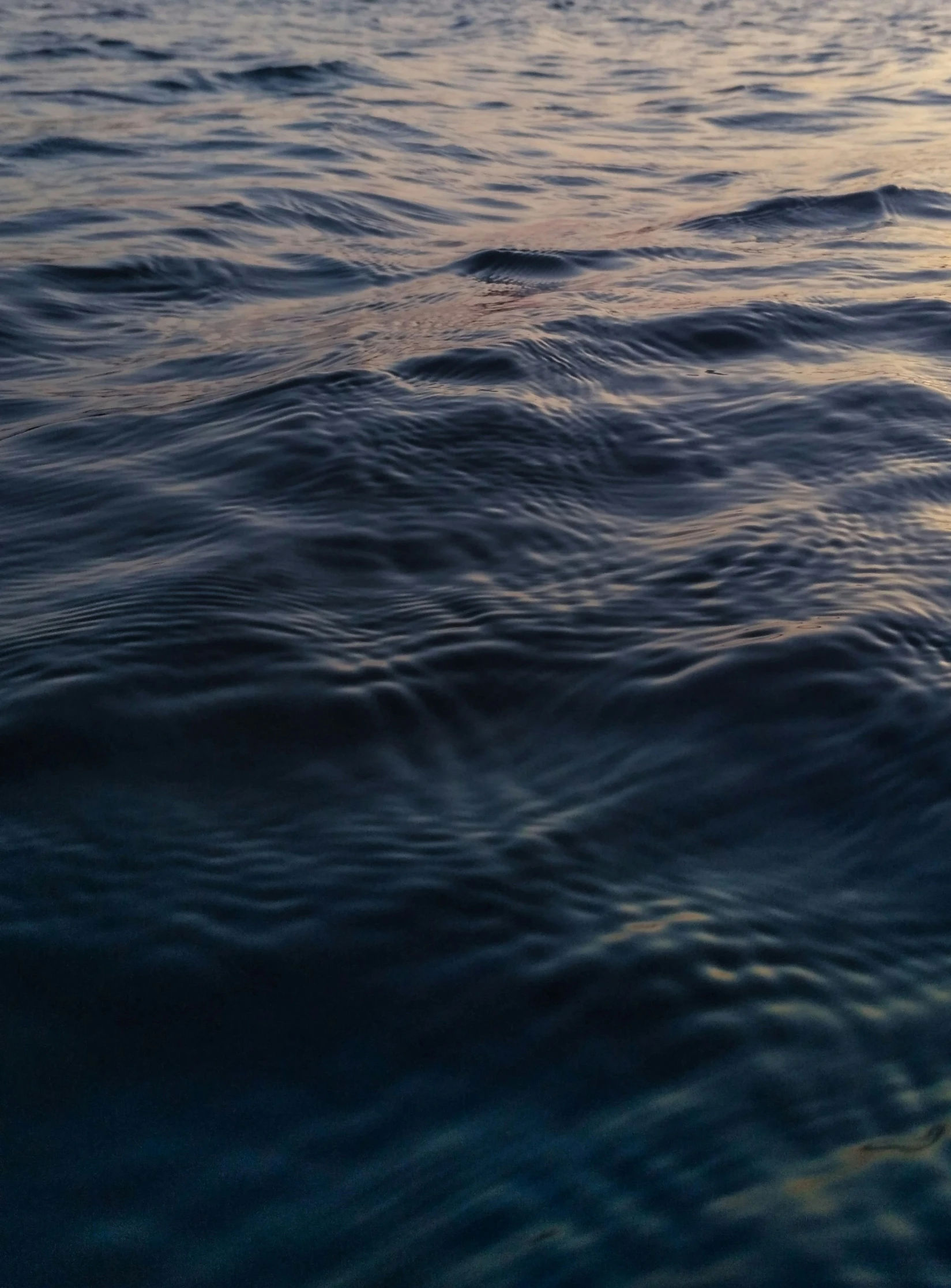 a calm lake with blue waves on the water