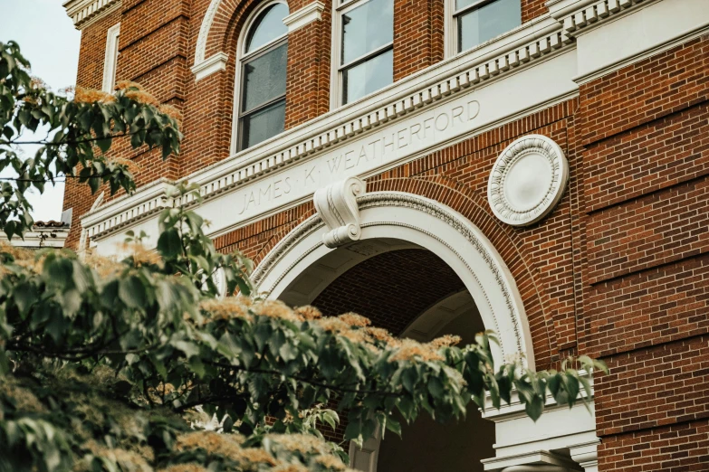 a tall building with arched windows and two clocks on it