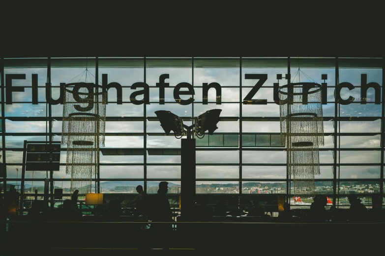 view of a glass and steel window with a city view behind it