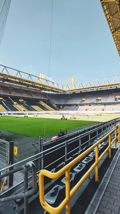 empty yellow stands inside an empty sports stadium